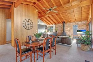 a kitchen and dining room with a wooden ceiling at Beachcombers on Collingwood Beach in Vincentia