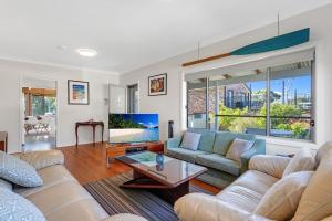a living room with a couch and a table at Berry by The Bay in Vincentia