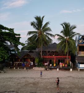 a couple of people standing on a beach at villa Mena in Nosy Be