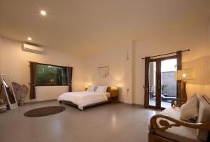 a bedroom with a bed and a large window at Villa Destino - Seminyak Bali in Seminyak