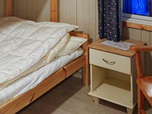 a bedroom with a bed and a night stand with a drawer at Two-Bedroom Holiday home in Gravdal 1 in Gravdal