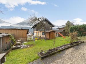 a backyard with a house and a yard with a fence at Large holiday apartment for groups in Lengdorf near Niedernsill in Niedernsill