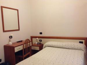 Postel nebo postele na pokoji v ubytování Hotel Ricci