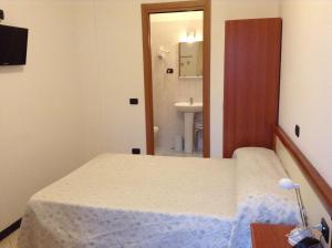 Postel nebo postele na pokoji v ubytování Hotel Ricci