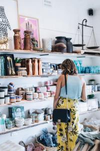 a woman standing in front of a shelf of ceramics at The Beach Studio in Huskisson