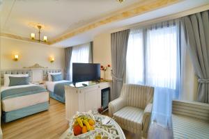 a hotel room with a bed and a living room at Yılsam Sultanahmet Hotel in Istanbul