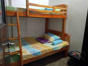 a bunk bed with a ladder in a room at Yem Homestay in Baguio