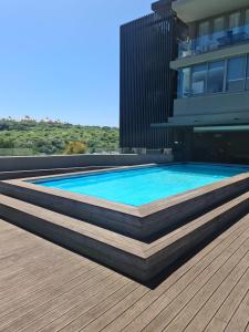 a swimming pool on the roof of a building at Umhlangha Oceans Dunes in Umhlanga