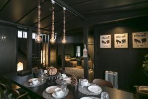 a dining room with a table and a living room at Hakuba Hatago Maruhachi in Hakuba +160 photos