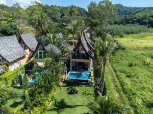 an aerial view of a house with a pool and palm trees at Villa Manipura in Ko Chang