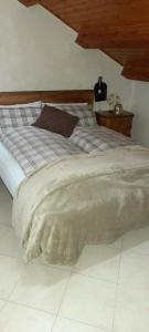 a bed with a blanket on it in a bedroom at Locanda San Martino in Massac
