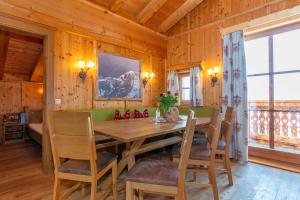 a dining room with a wooden table and chairs at Apartment Grammlergut in Maria Alm am Steinernen Meer
