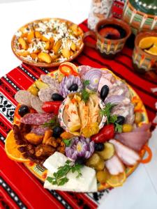 a platter of food on a red table at Hotel Dunavis in Orşova