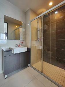 a bathroom with a sink and a glass shower at Bay Laurel, Country Garden Danga Bay Homestay By WELCOME HOME in Johor Bahru
