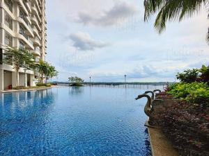 a large swimming pool in front of a building at Bay Laurel, Country Garden Danga Bay Homestay By WELCOME HOME in Johor Bahru