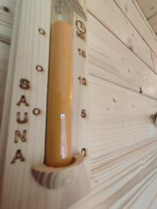 a candle hanging on a wall with letters on it at Lietadlo v lese in Spišské Bystré