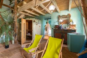 a kitchen with green chairs and a mirror at Hotel Zeit & Traum in Beatenberg