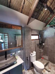 a bathroom with a toilet and a sink at Domu Mia Villa Siargao in General Luna