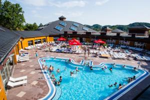 a group of people in a swimming pool at a hotel at Apartman President in Krapinske Toplice