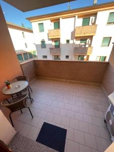 a balcony with a table and a building at Dave’s house in Reggio Emilia