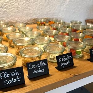 a bunch of jars filled with food on a table at Gästehaus Hotel Maria Theresia in Schliersee