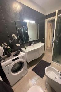 a bathroom with a washing machine and a sink at Dave’s house in Reggio Emilia