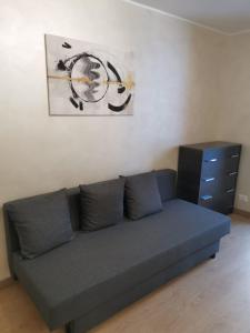 a couch in a living room with a painting on the wall at Belvedere Tonale in Passo del Tonale +35 photos