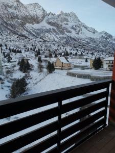 a view of a snow covered mountain from a balcony at Belvedere Tonale in Passo del Tonale
