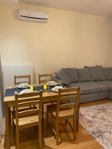 a living room with a table and chairs and a couch at Modern and New Family flat in Beylikdüzü in Beylikduzu