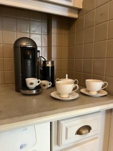 a kitchen counter with two cups and a coffee maker at Private Rooms & Bath in Tonneins +11 photos
