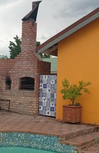 a brick fireplace on the side of a house at SONHOS dreams Self catering apartment Unit 1 in Bloemfontein