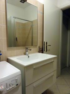 a bathroom with a white sink and a mirror at La Piazzetta in Sestri Levante