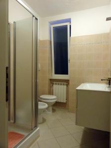 a bathroom with a toilet and a sink and a shower at La Piazzetta in Sestri Levante +2 photos
