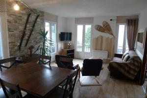 a living room with a table and a couch at Résidence Perce Neige in Luz-Saint-Sauveur