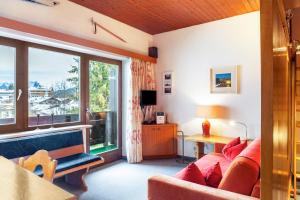 a living room with a couch and a window at Haus Excelsior Top 13 in Seefeld in Tirol