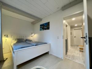a bedroom with a bed in a white room at Ferienwohnung Clyde in Sankt Andreasberg
