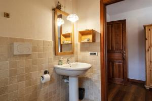 a bathroom with a sink and a mirror at Maison Le Champ B&B Questa casa non è un albergo in La Salle