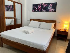 a bedroom with a bed with two towels on it at Alaia Studios in Panglao Island