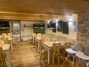 a restaurant with tables and chairs in a room at Penzion Pod lesem in Pec pod Sněžkou