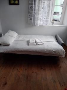 a bed sitting in a room with a window at Apartament z widokiem na Śnieżkę in Karpacz