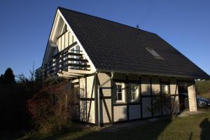 a white and black house with a black roof at Haus Maria in Ahlbeck