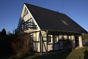una casa blanca y negra con techo negro en Haus Maria, en Ahlbeck