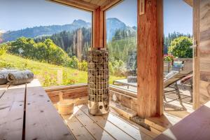 a room with a large window with a fireplace at Chalet Argali - OVO Network in Le Grand-Bornand