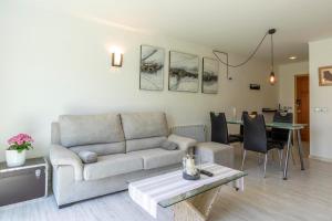 a living room with a couch and a table at VISTA MONTE II - Francisca in El Port