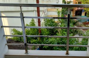 a view of a garden from a balcony at Hotel Amrit Bliss in Rishīkesh