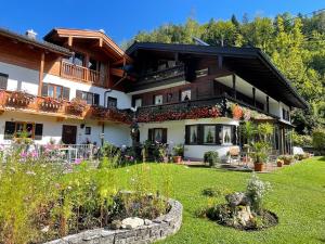 a large house with a garden in front of it at Gästehaus Deml in Berchtesgaden