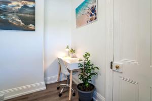 una oficina con escritorio y una planta en una habitación en One Bedroom Apartment on Summer/ No.2 near CBD en Orange
