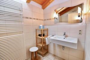 een badkamer met een wastafel en een spiegel bij Gästehaus Wechs in Bad Hindelang