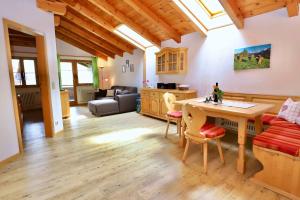 een keuken en een woonkamer met een tafel en stoelen bij Gästehaus Wechs in Bad Hindelang