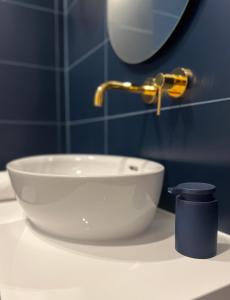 a white sink on a counter in a bathroom at Grand Apartament in Złotów